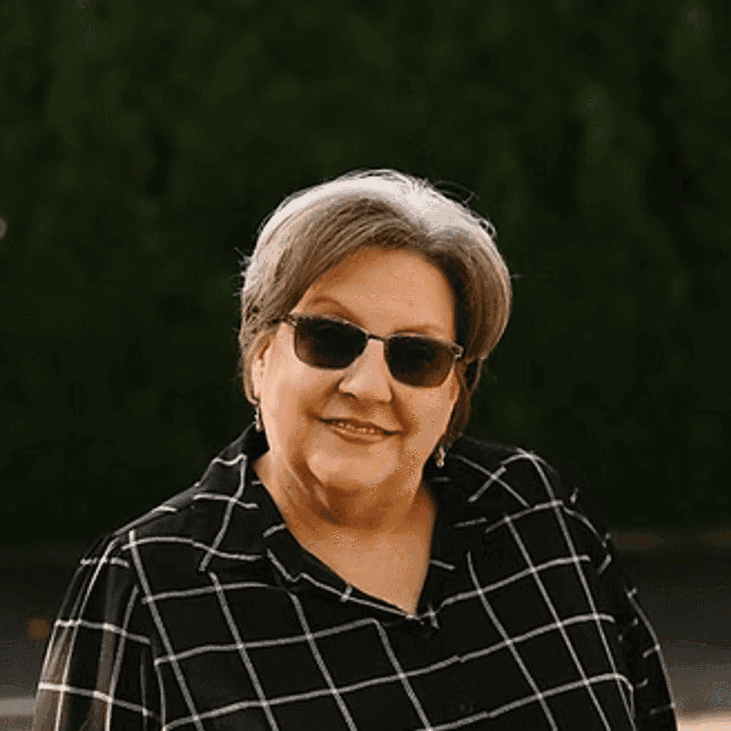 Portrait of Joan Gear, a professional stylist at Beautique Beauty Lounge, showcasing their expertise and style.