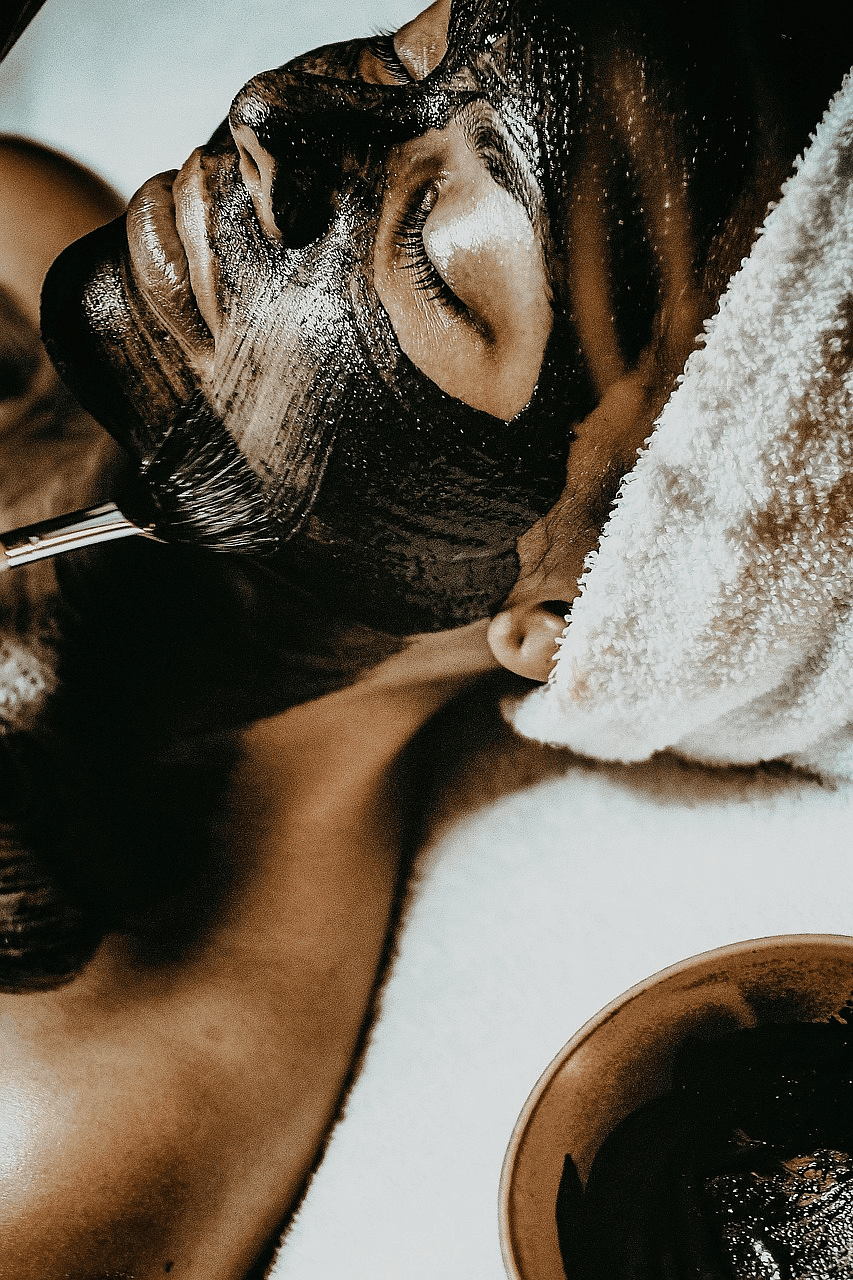 Person receiving a relaxing facial mask treatment at a spa.
