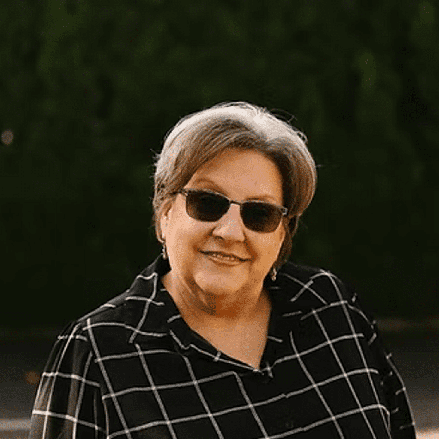 Portrait of Joan Gear, a professional stylist at Beautique Beauty Lounge, showcasing their expertise and style.