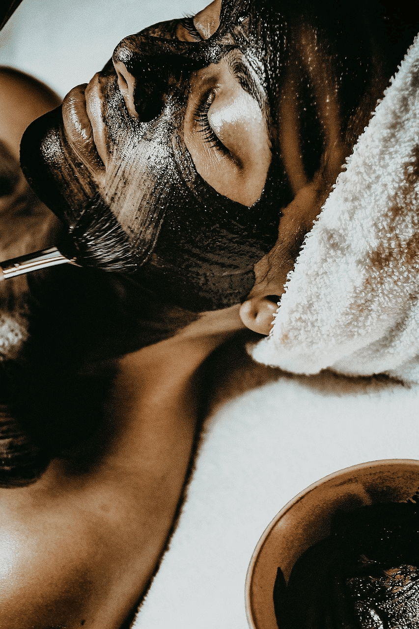 Person receiving a relaxing facial mask treatment at a spa.